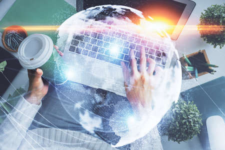 Double exposure of woman hands working on computer and financial theme hologram drawing. Top View....