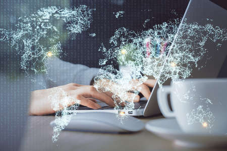 Double exposure of woman hands typing on computer and social network theme hologram drawing. People...