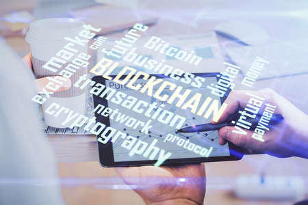 Double exposure of mans hands holding and using a phone and crypto currency blockchain theme drawing.の写真素材