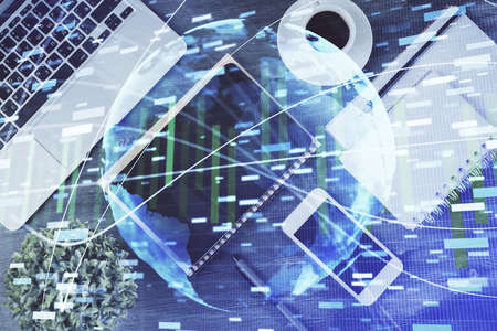 Double exposure of business theme hologram over desktop with phone. Top view. Mobile international...