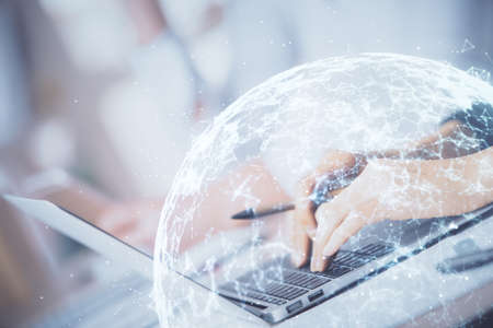 Double exposure of woman hands typing on computer and social network theme hologram drawing. People...