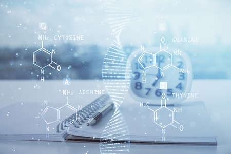 Double exposure of DNA drawing and desk with open notebook background. Concept of educationの写真素材