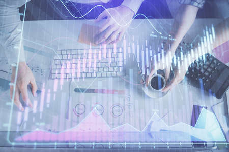Double exposure of man and woman working together and financial chart hologram drawing. market...
