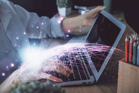 Double exposure of woman hands typing on computer and social network theme hologram drawing. People media concept.の写真素材