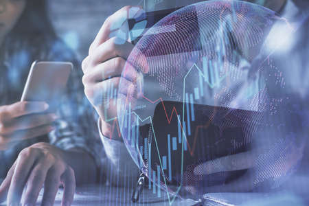 Double exposure of man and woman on-line shopping holding a credit card and forex graph hologram...