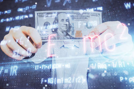 Multi exposure of Formulas drawing hologram and USA dollars bills and man hands. Educationの写真素材