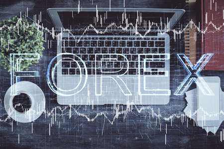 Stock market chart and top view computer on the table background. Double exposure. Concept of financial analysis.の写真素材