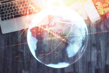 Business theme hologram drawings over computer on the desktop background. Top view. Multi exposure. Concept of international connections.の写真素材