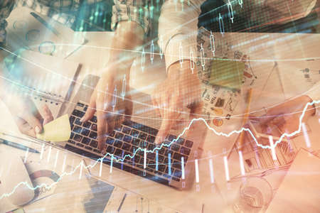 Multi exposure of man and woman working together and forex graph hologram drawing. Financial...