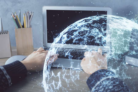 Double exposure of woman hands typing on computer and social network theme hologram drawing. People media concept.の写真素材