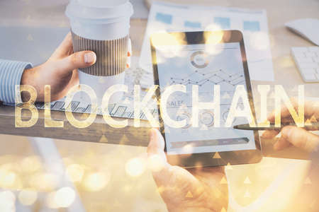 Double exposure of mans hands holding and using a phone and crypto currency blockchain theme drawing.の写真素材
