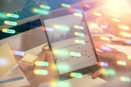 Multi exposure of mans hands holding and using a digital device and data theme drawing. Innovation...