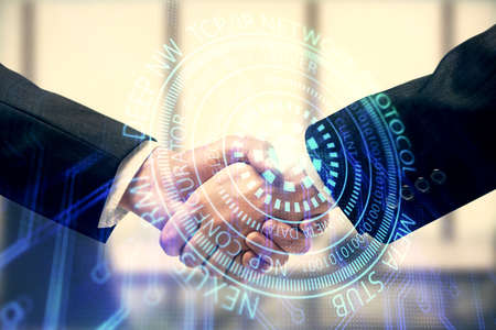 Double exposure of data theme hologram and handshake of two men. Partnership in IT industry concept.の写真素材