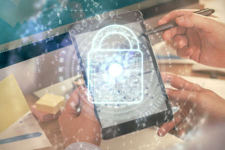 Multi exposure of mans hands holding and using a digital device and lock drawing. Security concept.