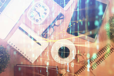Double exposure of technology theme drawing over work table desktop. Top view. Global data analysis concept.の写真素材