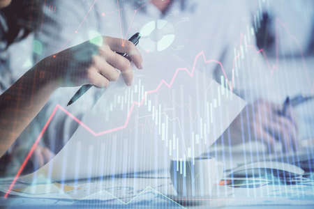 Double exposure of forex graph drawing over people taking notes background. Concept of financial...