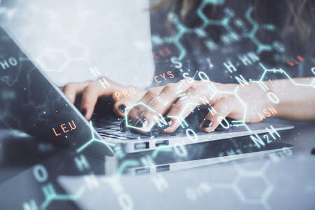 Double exposure of woman hands typing on computer and formula hologram drawing. Education concept.の写真素材