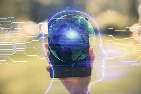 Double exposure of brain sketch hologram and woman holding and using a mobile device.の写真素材