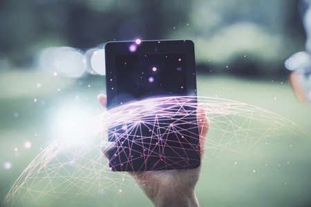 Double exposure of social network sketch hologram and woman holding and using a mobile device.の写真素材