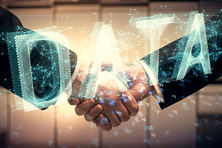 Double exposure of data theme hologram and handshake of two men. Partnership in IT industry concept.