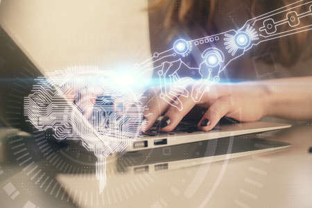 Double exposure of woman hands working on computer and brain hologram drawing. Ai concept.の写真素材