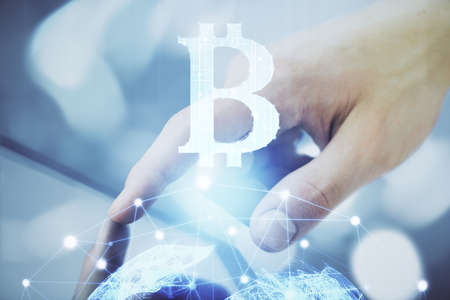 Double exposure of mans hands holding and using a phone and crypto currency blockchain theme...