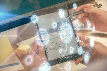 Multi exposure of mans hands holding and using a digital device and data theme drawing. Innovation concept.の写真素材