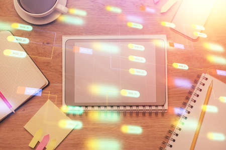 Double exposure of technology theme drawing over work table desktop. Top view. Global data analysis...