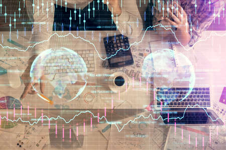 Double exposure of man and woman working together and financial graph hologram drawing. market...