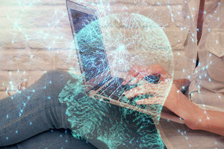 Multi exposure of woman hands working on computer and brain hologram drawing. Ai concept.の写真素材