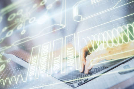 Double exposure of woman hands typing on computer and general theme hologram drawing. Education...