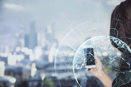 Double exposure of social network sketch hologram and woman holding and using a mobile device.の写真素材