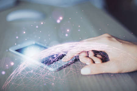 Double exposure of social network sketch hologram and woman holding and using a mobile device.の写真素材