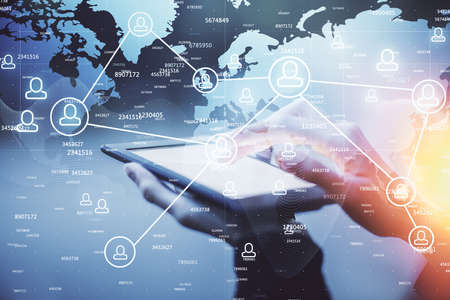 Double exposure of social network sketch hologram and woman holding and using a mobile device.の写真素材