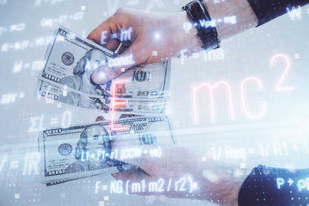 Multi exposure of Formulas drawing hologram and USA dollars bills and man hands. Educationの写真素材