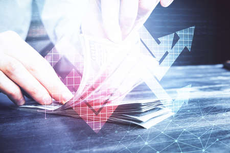 Multi exposure of arrows drawing hologram and USA dollars bills and man hands. Growth concept.の写真素材