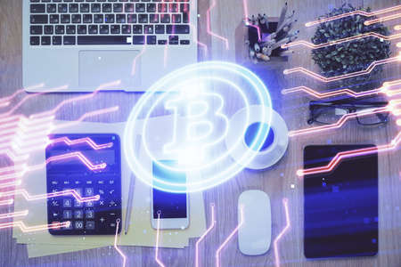 Double exposure of blockchain theme hologram over table with phone. Top view. Crypto technology...