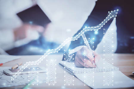 Double exposure of forex chart drawing over people taking notes background. Concept of financial analysisの写真素材