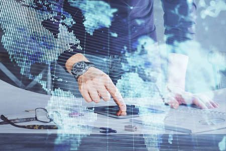 Double exposure of mans hands holding and using a phone and international business theme drawing.の写真素材