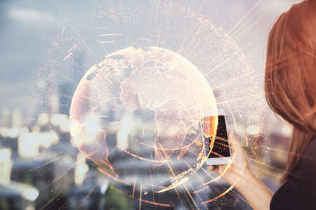 Double exposure of social network sketch hologram and woman holding and using a mobile device.