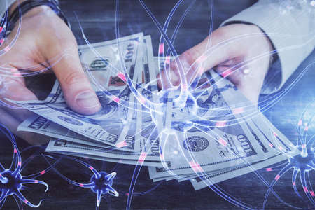 Multi exposure of neuron drawing hologram and USA dollars bills and man hands. Educationの写真素材