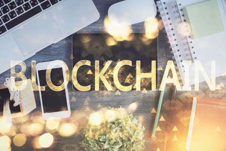 Double exposure of blockchain theme hologram over table with phone. Top view. Crypto technology concept.の写真素材