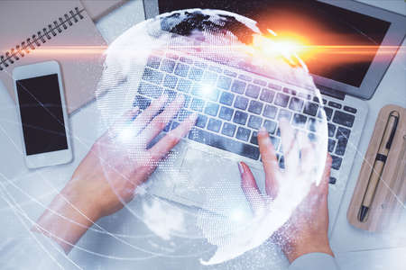 Double exposure of woman hands working on computer and financial theme hologram drawing. Top View....