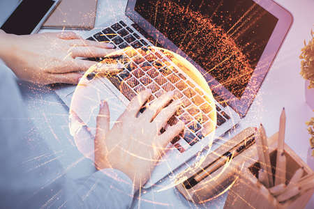 Double exposure of woman hands typing on computer and social network theme hologram drawing. People media concept.の写真素材