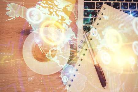 Double exposure of financial chart drawing over table background with computer. Concept of research and analysis. Top view.の写真素材