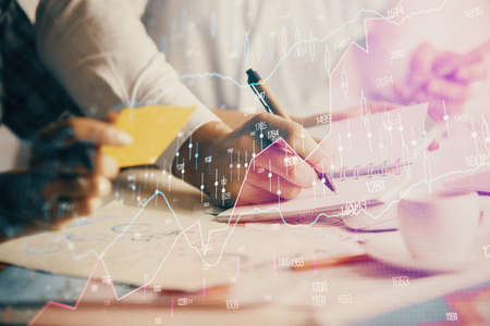 Double exposure of forex graph drawing over people taking notes background. Concept of financial...