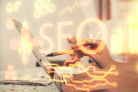 Double exposure of woman hands working on computer and seo hologram drawing. internet search concept.の写真素材