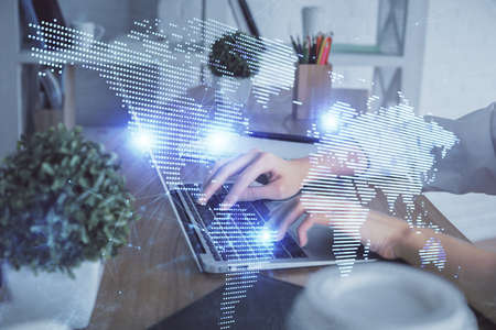 Double exposure of woman hands typing on computer and social network theme hologram drawing. People...