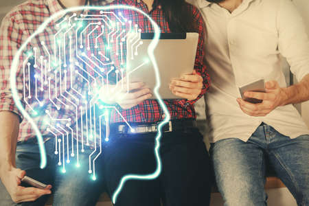Double exposure of man and woman working together holding and using a mobile device and brain hologram drawing.の写真素材