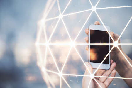 Double exposure of social network sketch hologram and woman holding and using a mobile device.